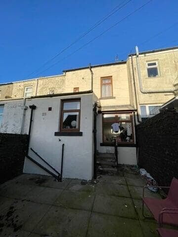 Damp proof treatment to the rear of a rendered stone terraced house in Darwen