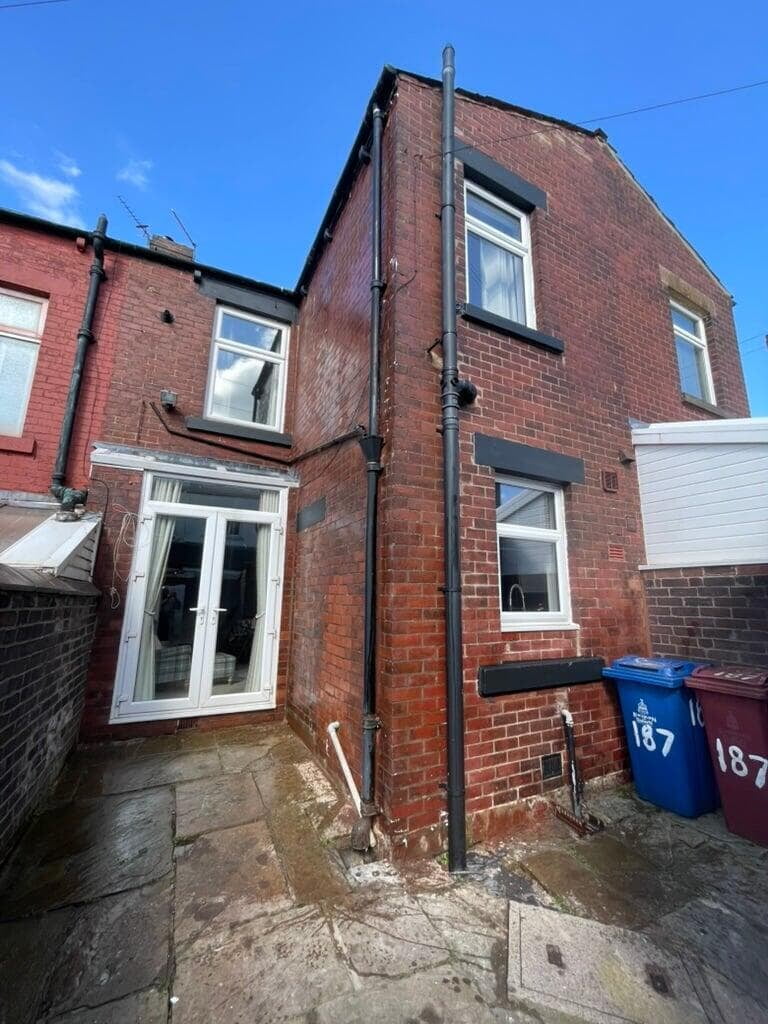 Damp proof treatment to the rear of a brick terraced house in Darwen