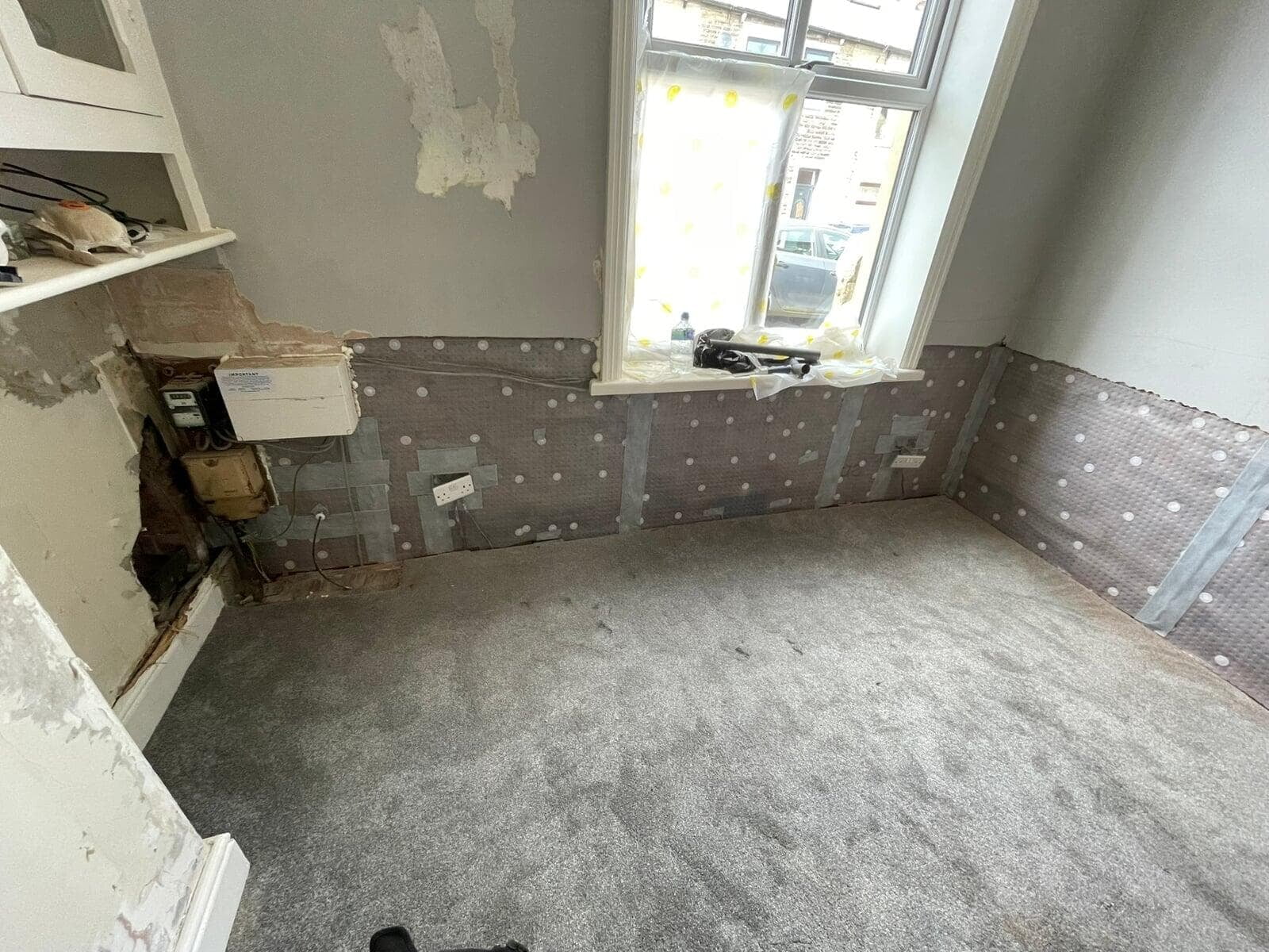 Waterproof membrane fitted to the lower wall beside a window, Great Harwood